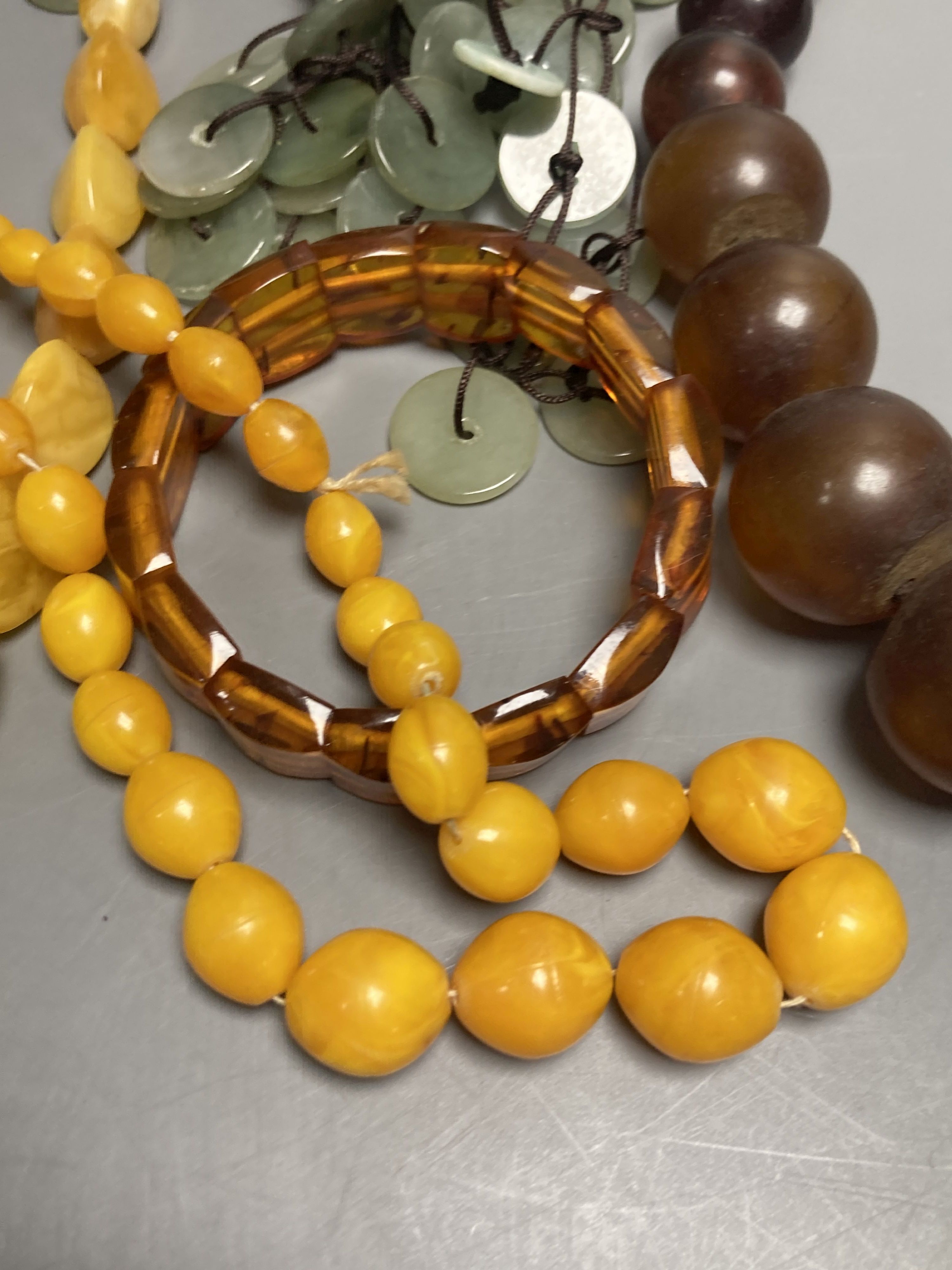 A pale yellow amber bead necklace, 56cm, gross 45 grams and other necklaces including simulated amber.